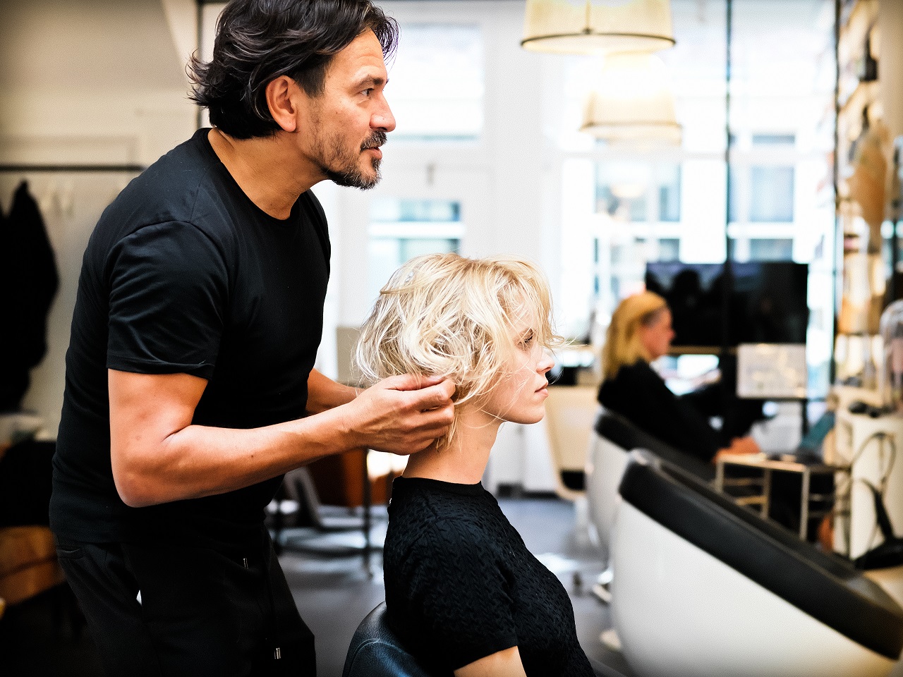 Een stylist van Haarhemel brengt een kapsel in model